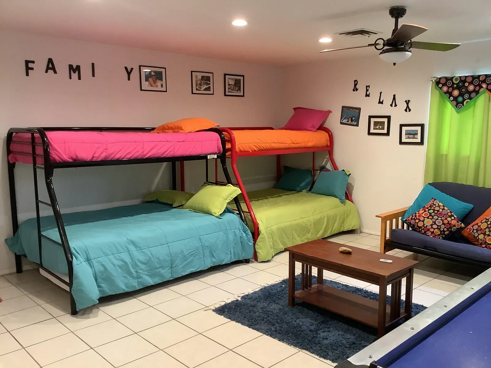 bedroom #5 showing two bunk beds, a center table and half of a futon