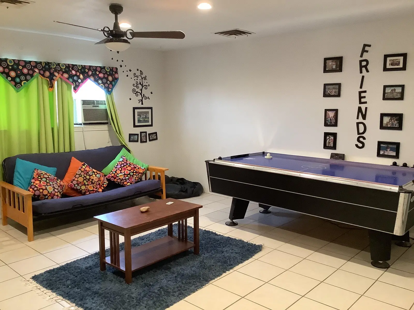 bedroom #5, showing a futon, a center table and an airhockey table
